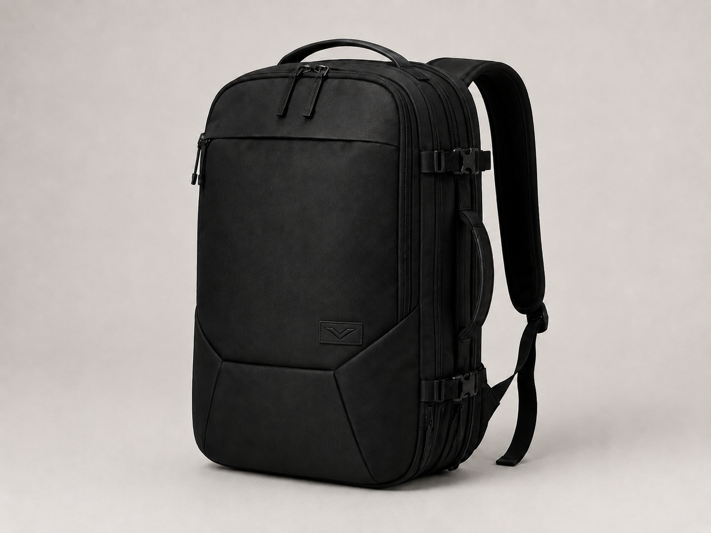 VELT Travel Backpack — expandable, all-black with debossed V logo